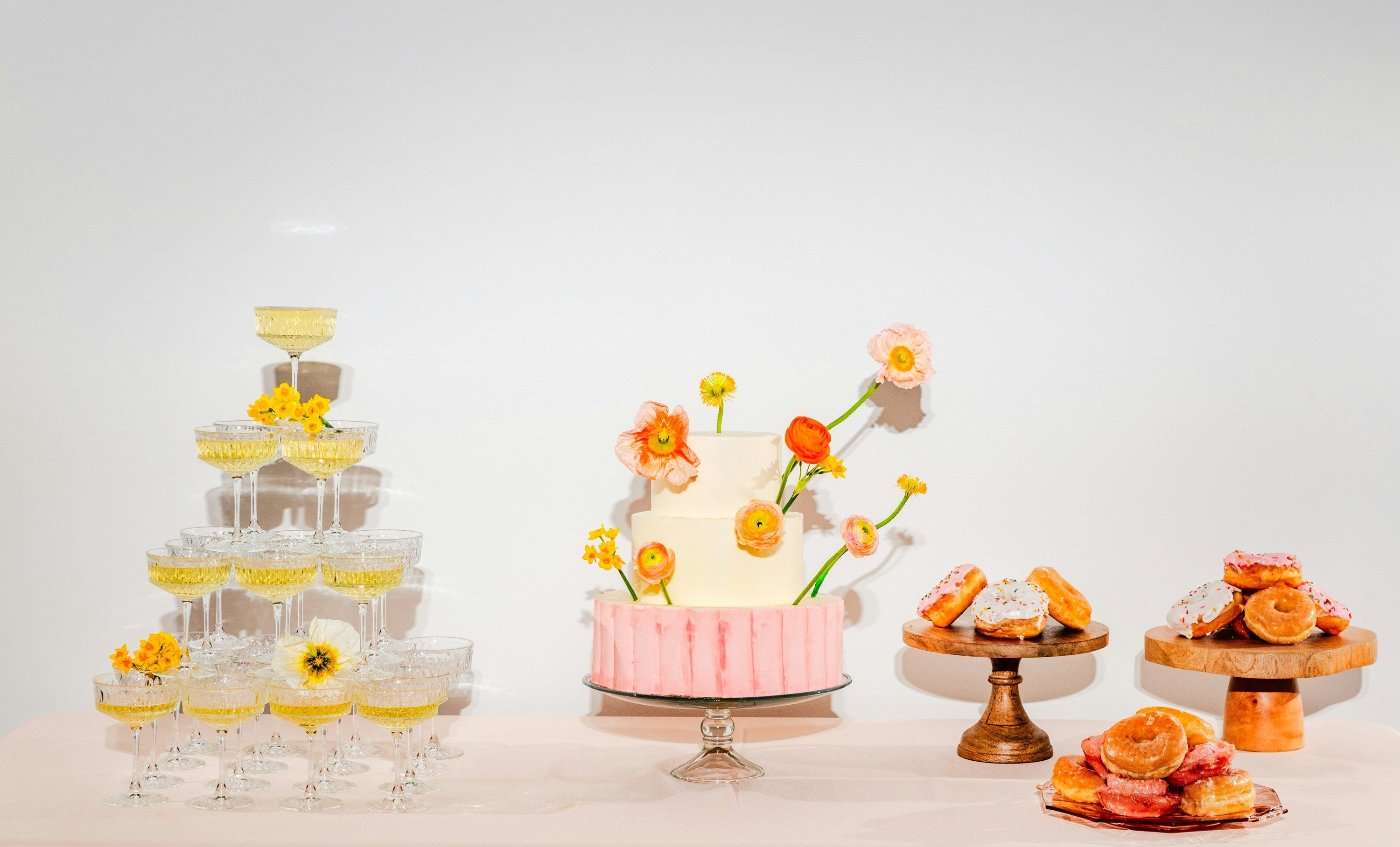 Decorative cake stand with a white cake and floral decorations on a light background